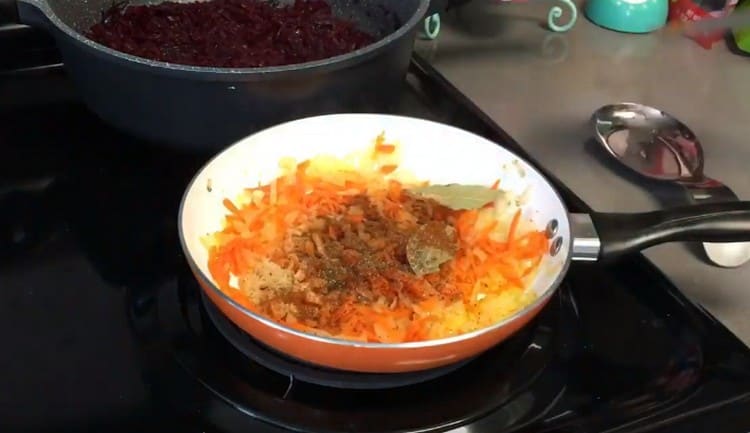 Add carrot to the onion in the pan, and then spices and bay leaf.