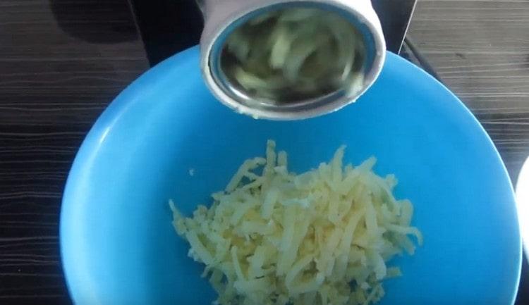 Three boiled potatoes on a coarse grater.