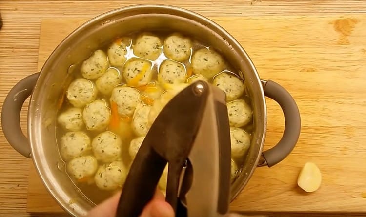 Squeeze the garlic into the soup through a press.