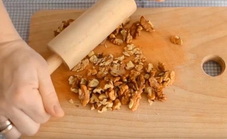 We chop walnuts with a rolling pin.