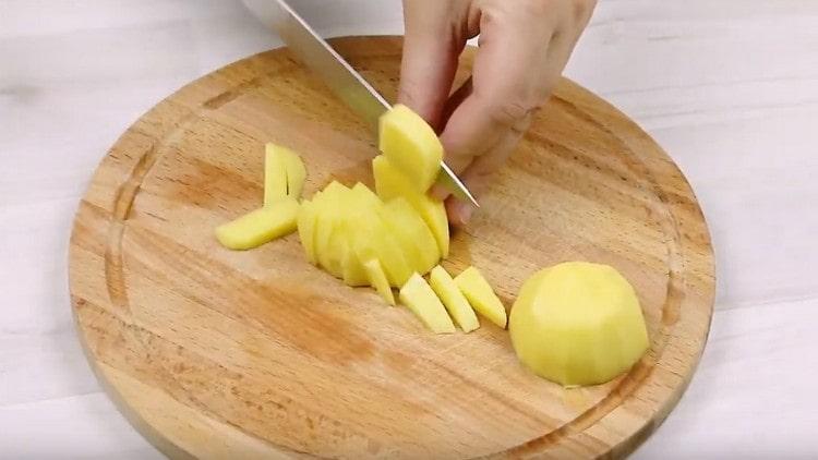 Peel and cut the potatoes into pieces.