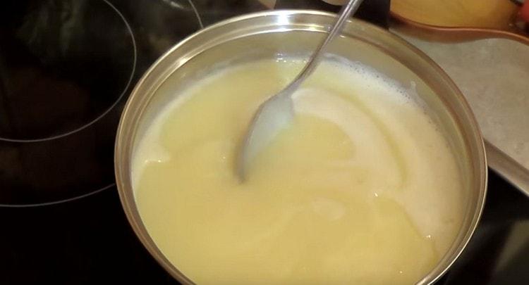 Cook the custard base for the cream until thickened.