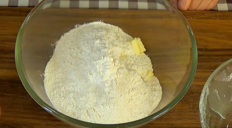 Put butter and flour into slices in a bowl.