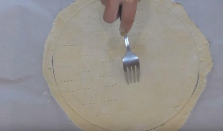 Transfer the cake directly on the parchment onto a baking sheet and prick it with a fork.