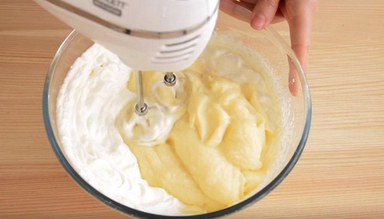 Add the custard base to the cream and whisk again.
