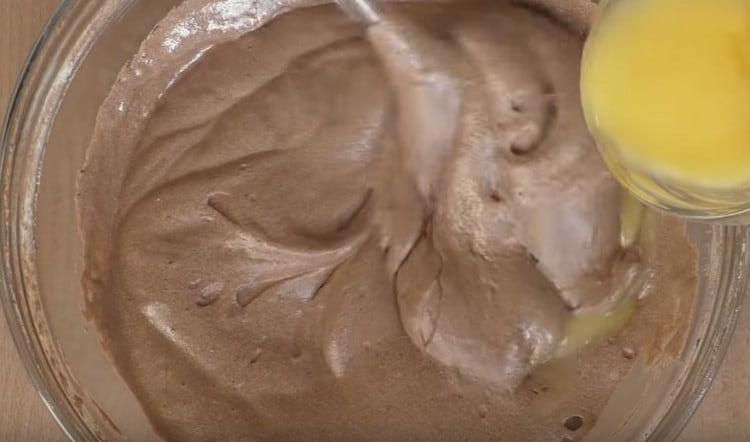 Carefully introduce melted and already cooled butter into the dough.