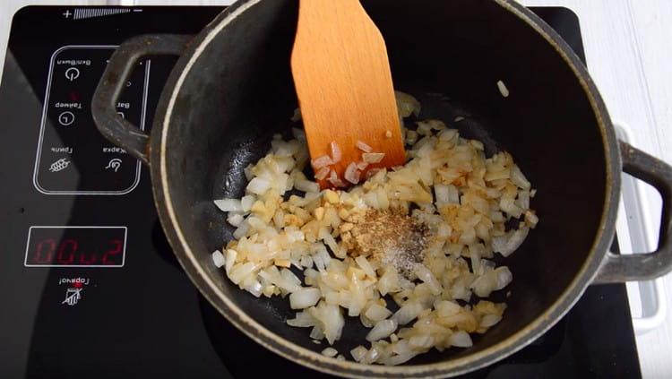 Add spices to the onion with garlic.