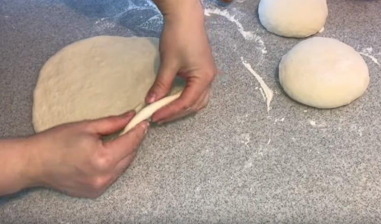 We roll out each piece of dough with a sufficiently thick layer.