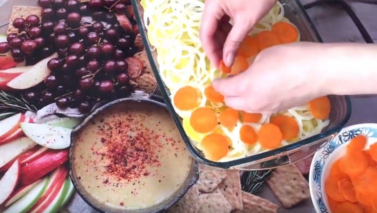 Couper les carottes en cercles et les répartir sur la couche d'oignon.