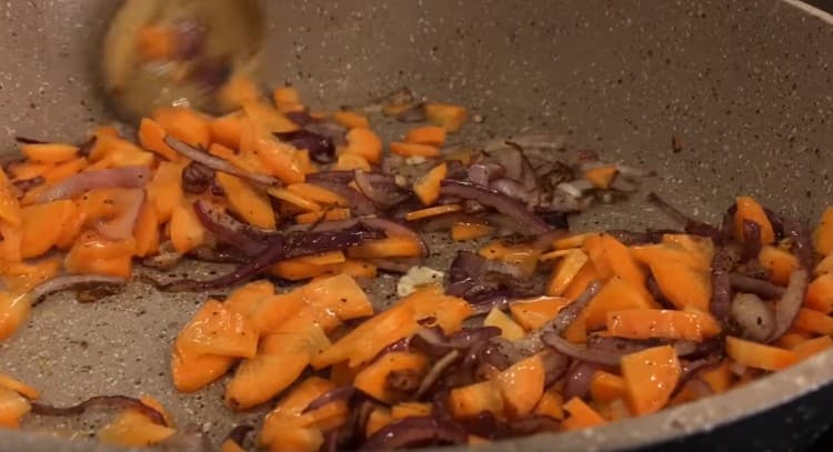 Luego agrega zanahorias a la cebolla y fríe por unos minutos más.