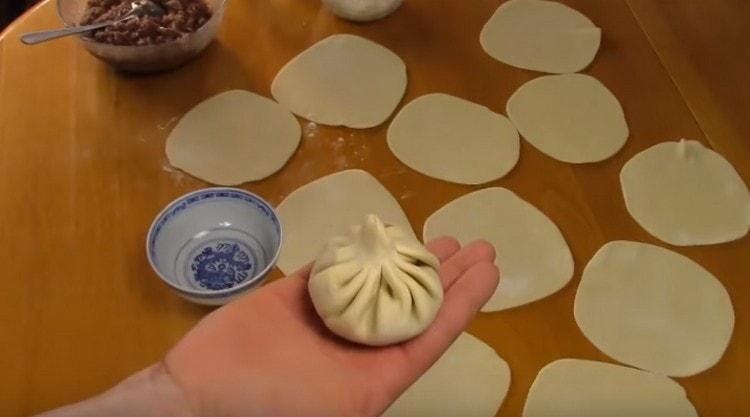 We carefully pinch the edges of the bag; excess dough can be cut.