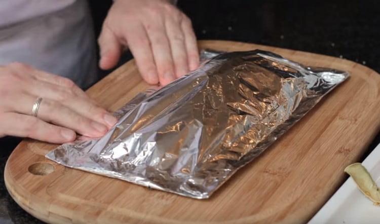 Cover the fish with another sheet of foil and carefully wrap.