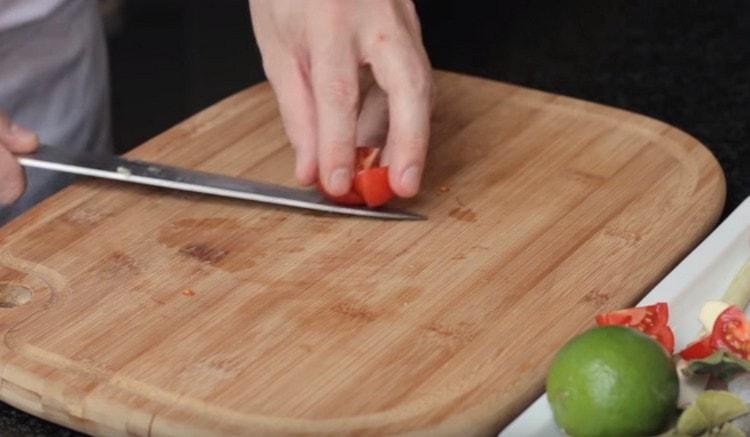 Cherry tomatoes are cut into several pieces.