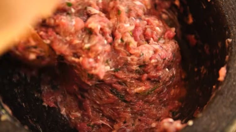 Stir the minced meat thoroughly by adding water to it.