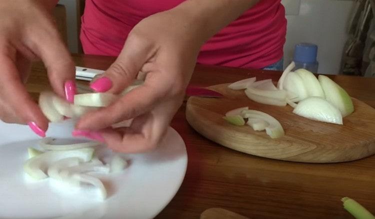 Cut the onion into half rings and divide them.