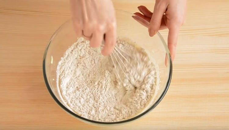 In parts, we begin to introduce flour and knead the dough.