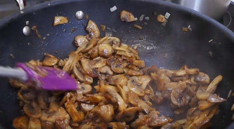 Add mushrooms to the onion and fry until cooked.