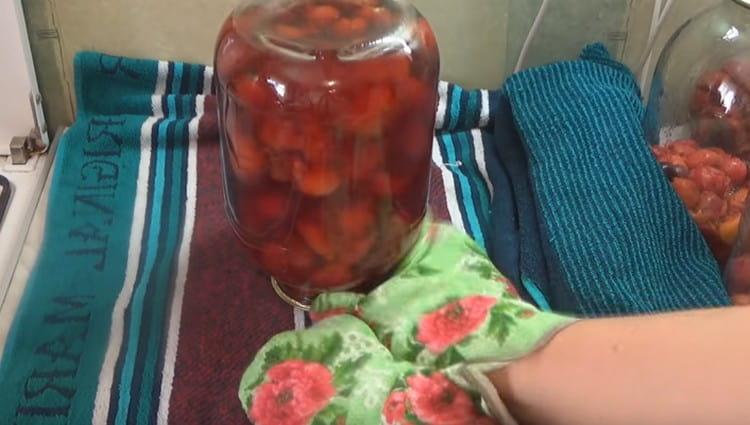 After seaming, the jars with compote from the plum need to be turned upside down and left to cool completely.