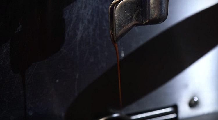 Using a coffee machine, brew espresso.