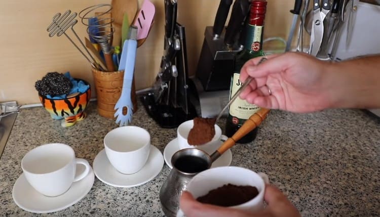 Freshly ground coffee is poured into a turka.