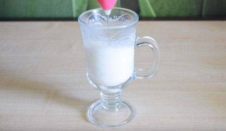 Beat milk with a mini-mixer.