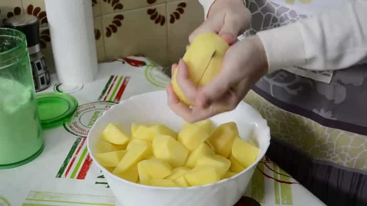 To cook chicken legs with potatoes in the oven, chop the potatoes