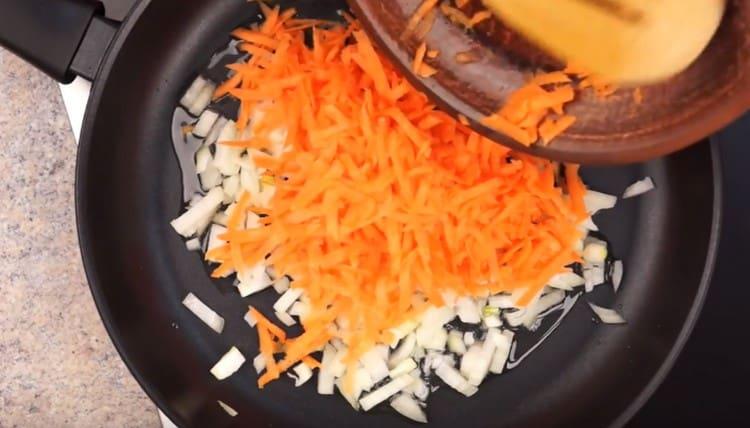 Fry onions with carrots in a pan.