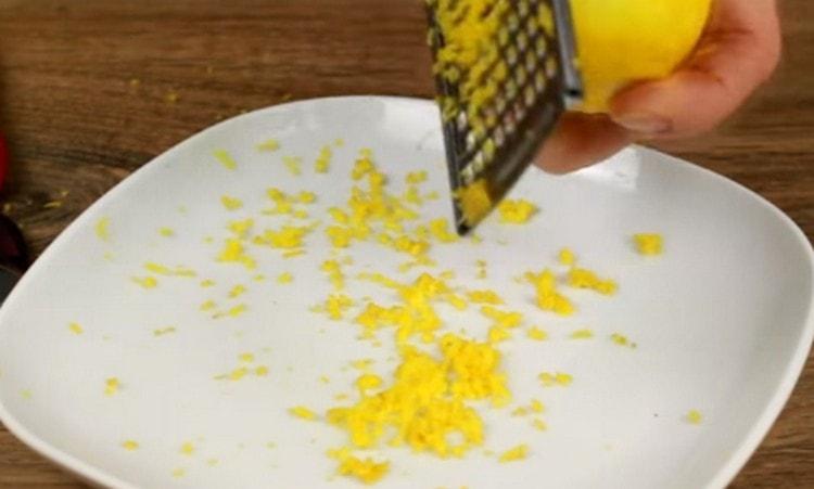 Rub the lemon zest on a grater.