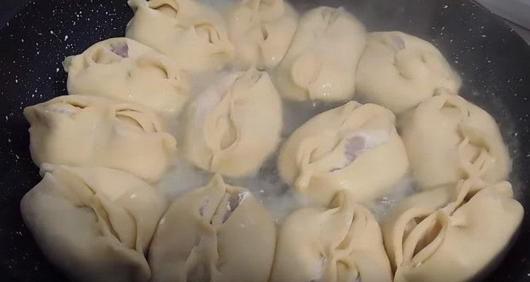 Add water to the pan, cover and cook the dish.