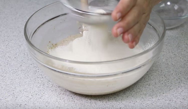 Sift flour into almond dough.