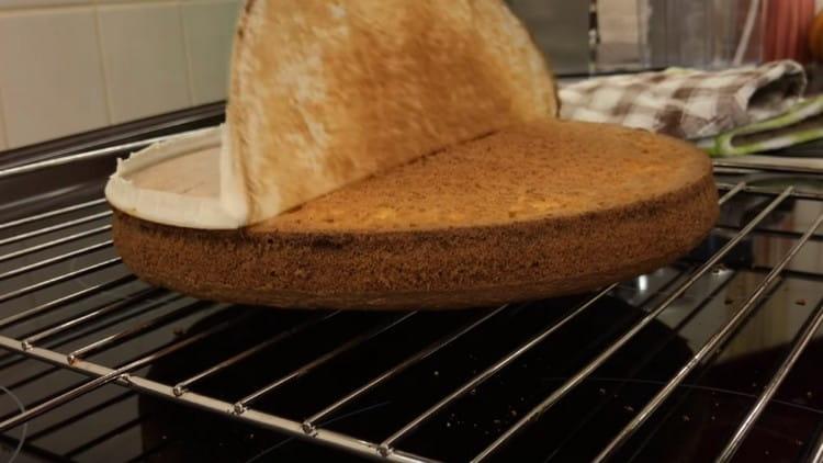 Turn the cake onto the wire rack, remove the parchment from it and leave it to cool.