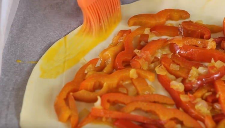 The edges of the dough are greased with whipped yolk.