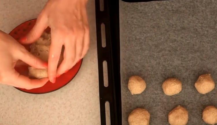 we cover the baking sheet with parchment and put dough balls on it.