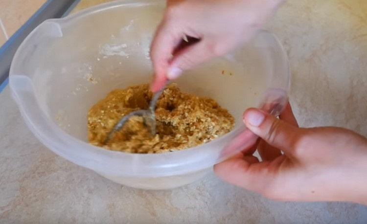 Stir the oat dough with a spoon.