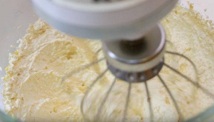 À l'aide d'un mélangeur, battez le beurre avec le sucre et l'œuf en une masse légère et luxuriante.