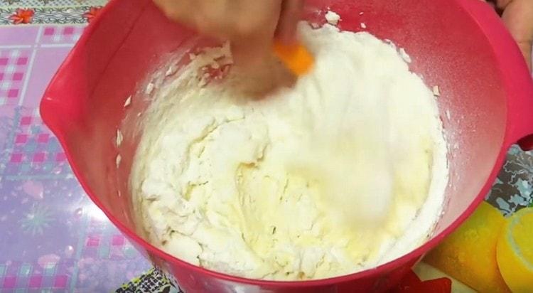 Add another part of the flour and mix the mass with a spoon.