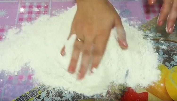 The remaining flour is distributed over the working surface.