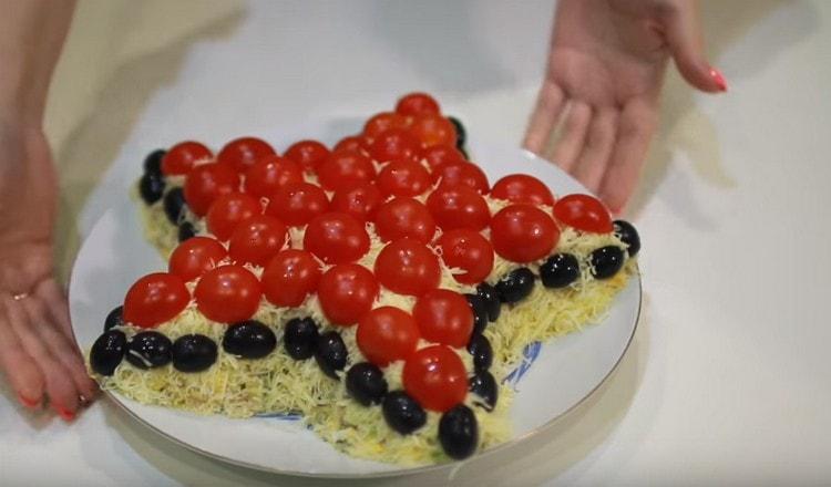 Along the edge, decorate the dish with halves of olives.