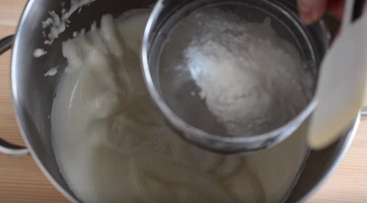 Gently sift the flour into the air mass.