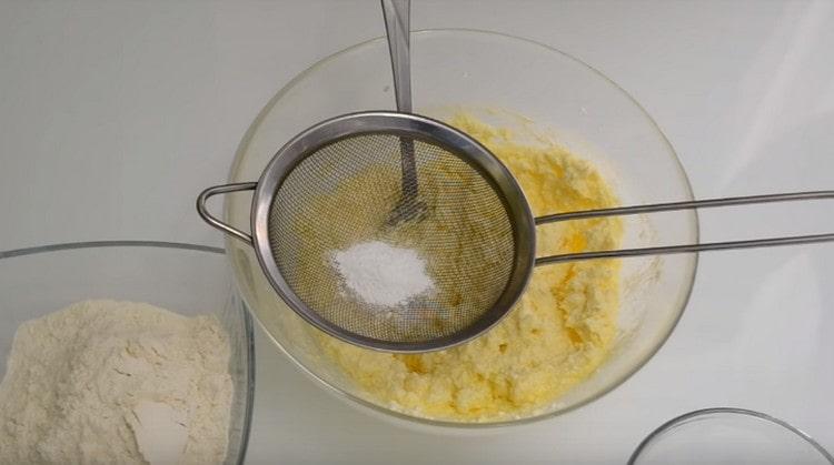 We sift the baking powder into the curd mass through a sieve.