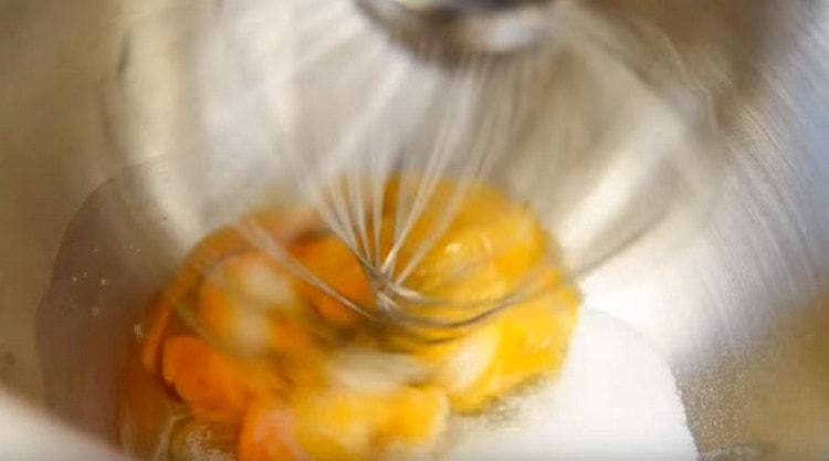 Beat eggs with sugar with a mixer.