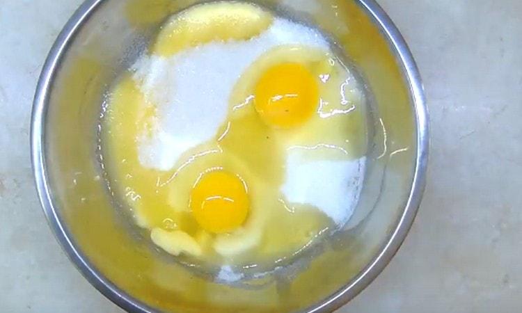 Add the eggs and sugar to the cooled oil.