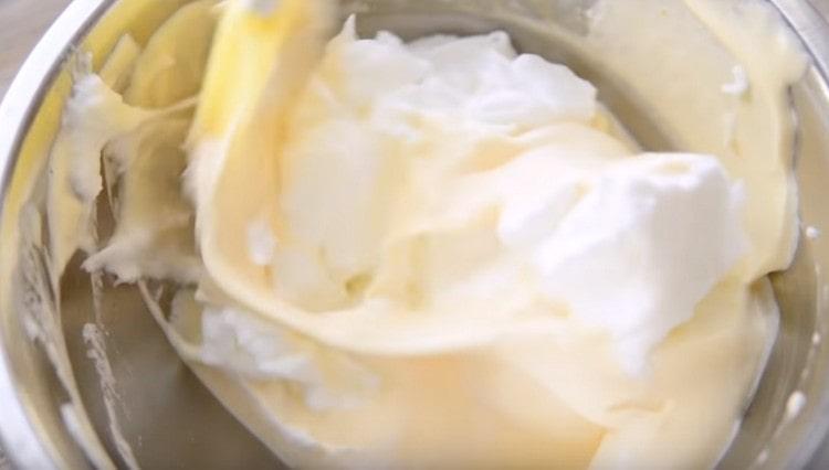 Mix the whipped whites with the yolks very carefully.