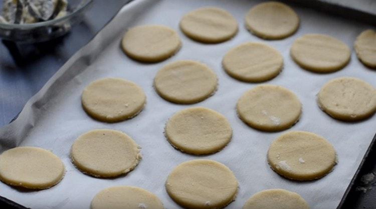 We shift the cookies onto a baking sheet, which must first be covered with parchment.