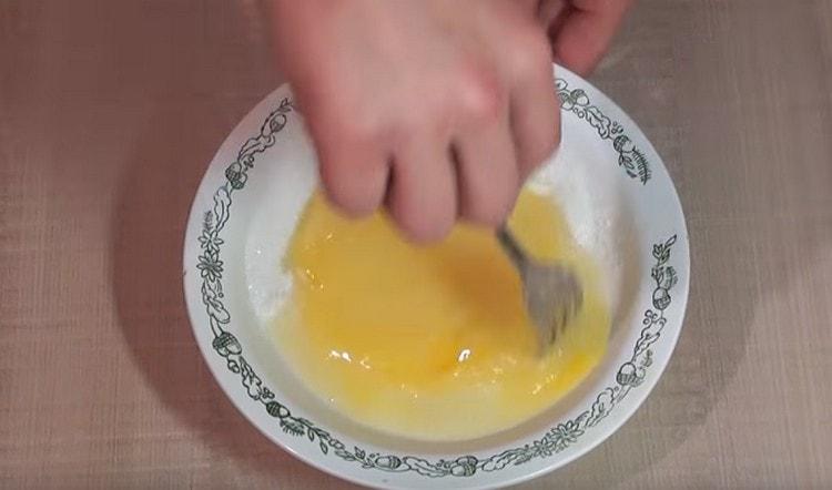 Battre légèrement les œufs avec du sucre.