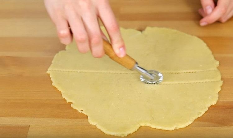 We cut the dough into strips with a curly or simple knife.