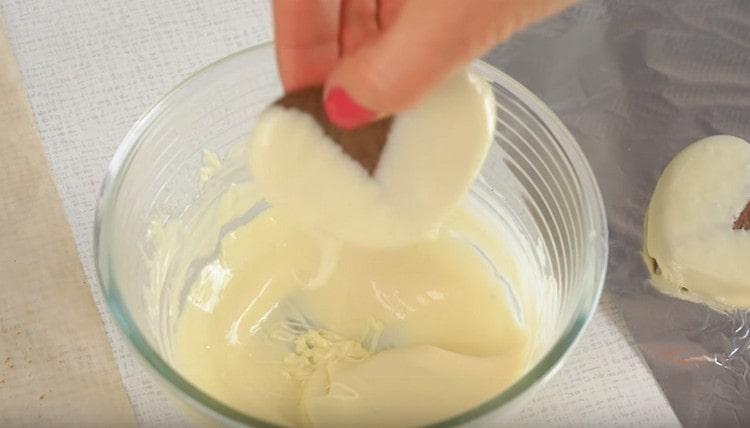 Dip each cookie in white chocolate.