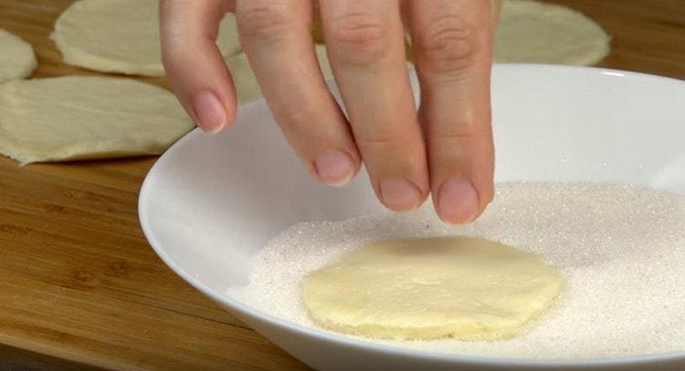 Dip each circle in sugar.