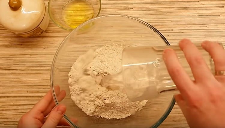 Pour whole grain flour into a bowl, add water.