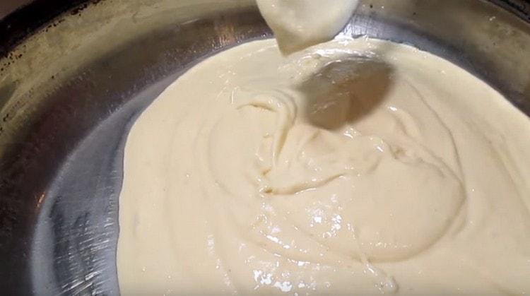 Pour half the dough onto the bottom of the mold.